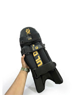 DuL DuL Batting Pads in black with front straps and padded protection.