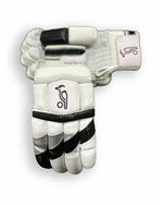 Black and grey Kookaburra batting gloves with padded palms and adjustable wrist straps.