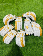 Manger Gold Edition batting gloves with padded palms and finger protection, designed for cricket players.