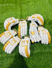 Manger Gold Edition batting gloves with padded palms and finger protection, designed for cricket players.