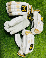 White and gold Manger batting gloves designed for beginners, featuring padded palms and adjustable wrist straps.