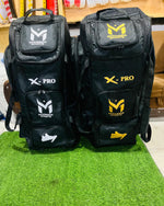 Manger X-Pro Elite Coffin Wheelie Bag with front pocket, sturdy handle, and large wheels for easy travel.