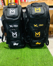 Manger X-Pro Elite Coffin Wheelie Bag with front pocket, sturdy handle, and large wheels for easy travel.