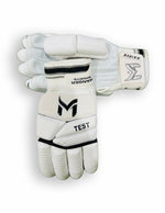 Manger Test Edition batting gloves with black and white design, padded palms, and adjustable wrist straps for cricket players.